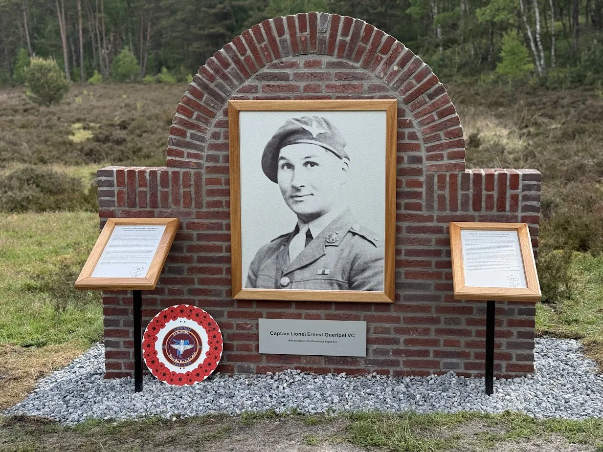 Stone memorial to Captain Lionel Queripel VC beside a road near Wolfheze, opposite the culvert where he was last seen in September 1944.