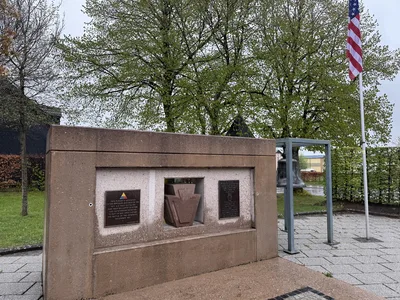 The 28th Infantry Division and 707th Tank Battalion monument at the crossroads in Marnach, Luxembourg, with the memorial bell behind it.