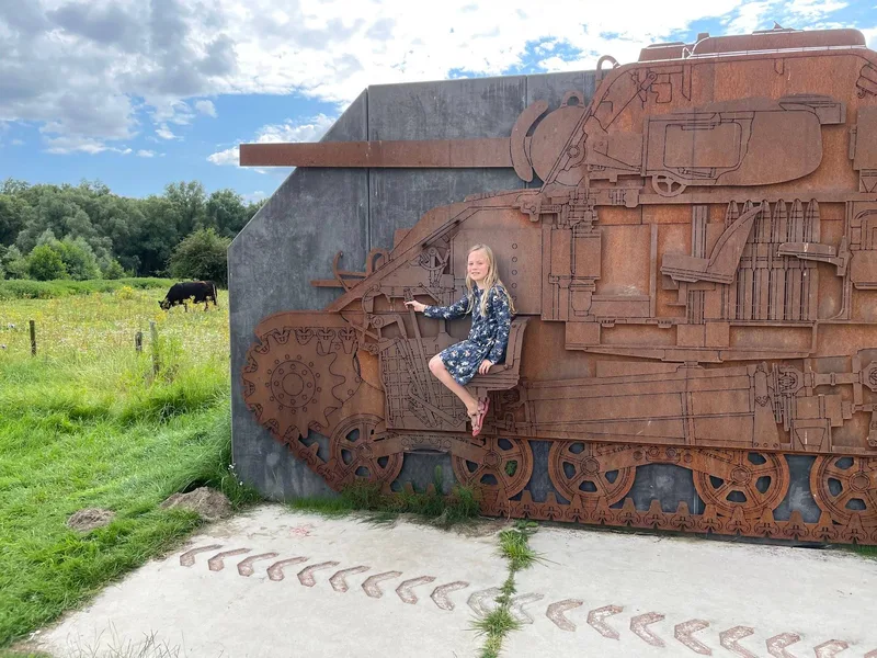 A child sitting in the driver's seat of the steel Sherman relief at Meinerswijk