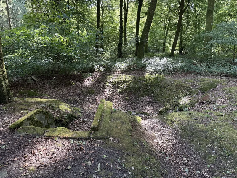 Bomb crater from the July 1944 raids at V1 Site Nr 161 at Guerville, a moss-covered concrete footing on its edge